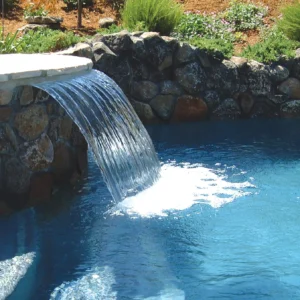 A waterfall is shown in the middle of a pool.