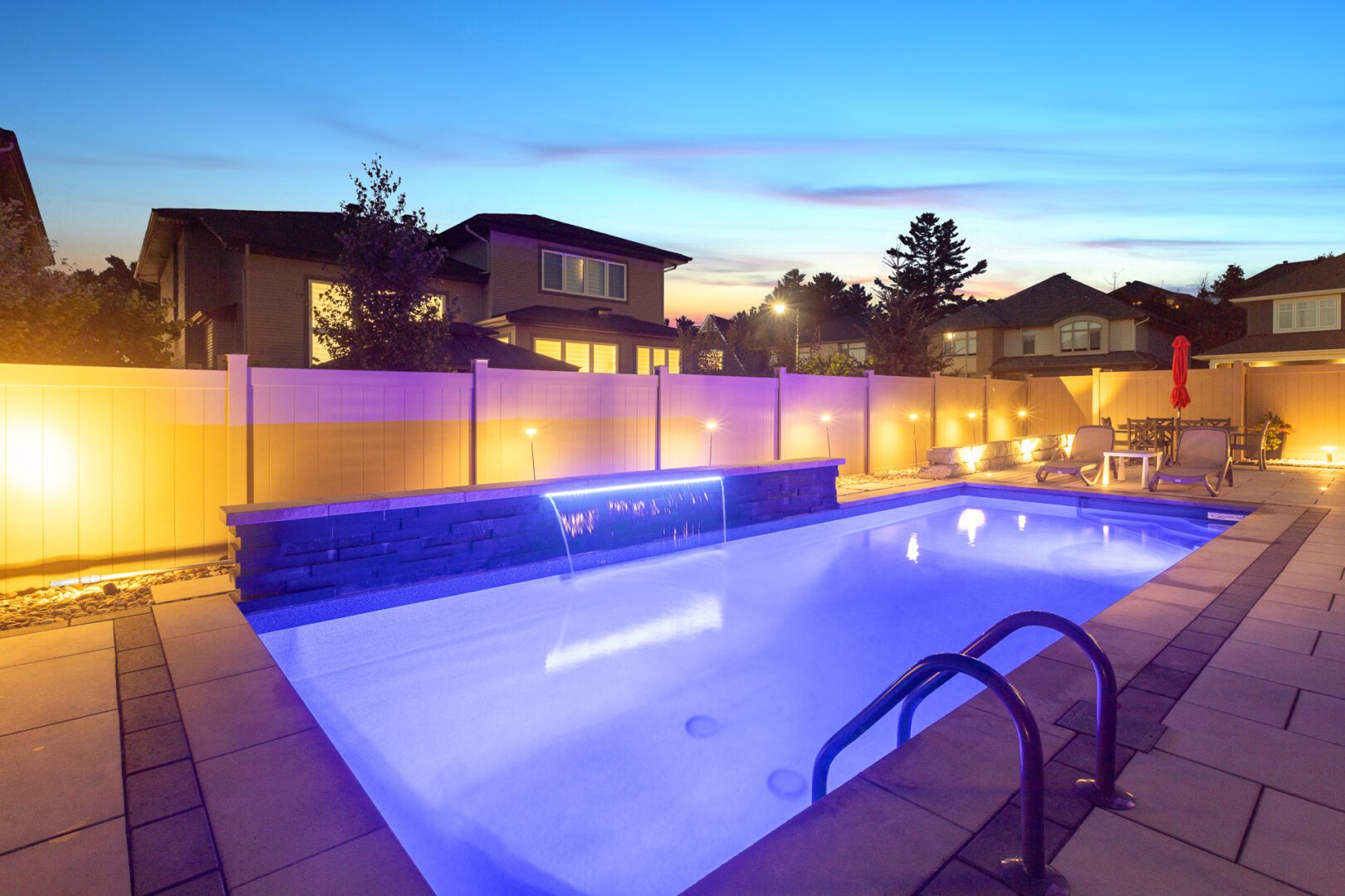 A pool with lights on the side of it