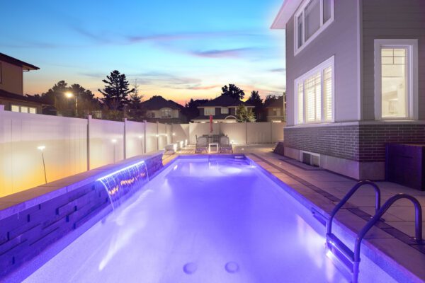 A pool with lights on the side of it