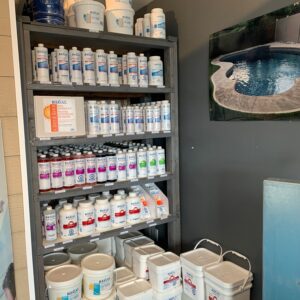 A shelf filled with lots of milk and other items.